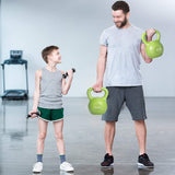 Man and child holding green kettlebells in a gym setting